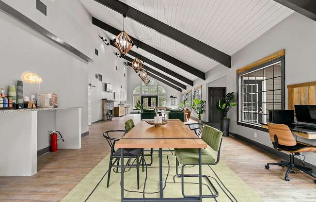 A modern office space with a long wooden table surrounded by chairs.