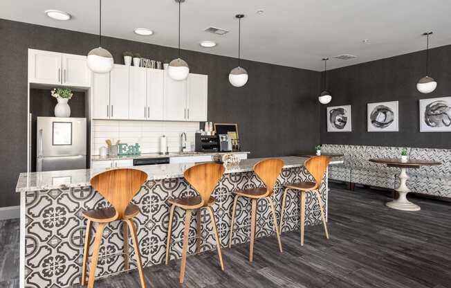 a kitchen with bar stools and a counter top in a living room