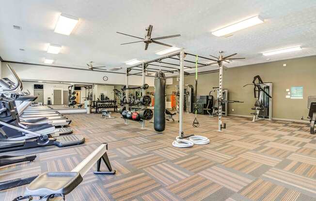 a spacious fitness center with weights and cardio equipment