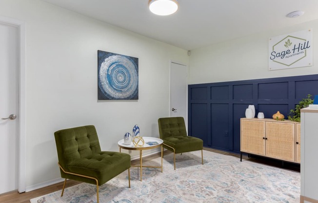 a living room with two green chairs and a coffee table