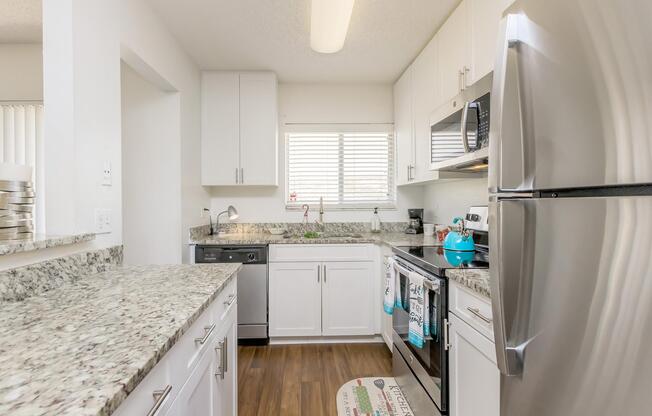 a kitchen with a sink and a refrigerator