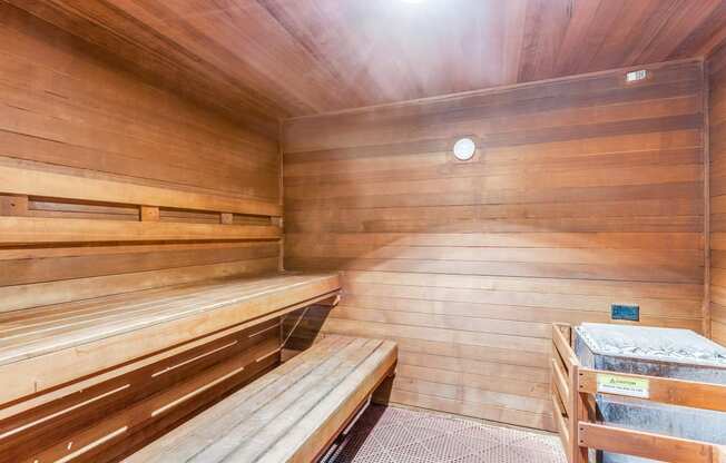 a sauna with wooden benches and a table