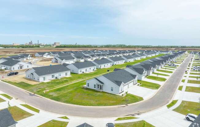 A row of houses with a road in front of them.