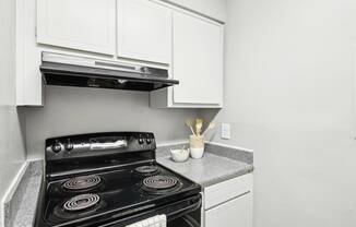 Modern and fully-equipped kitchen area at Pine Village North in Smyrna, GA