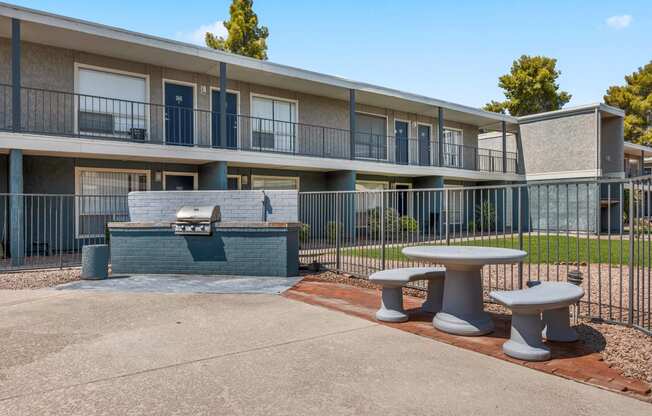 our apartments have a patio with a fire pit and tables