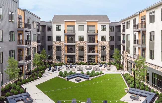 an aerial view of an apartment complex with a green courtyard