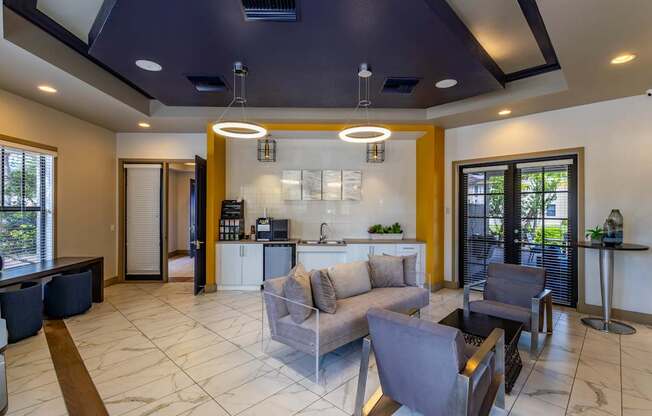 A modern living room with a kitchen area in the background.