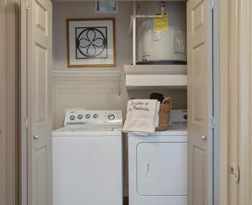 a small laundry room with a washer and dryer at Volare at the Woodlands, The Woodlands, TX, 77384