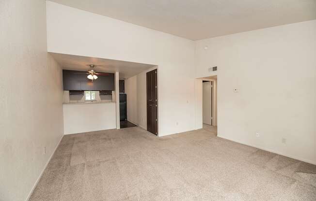 A room with a carpeted floor and a ceiling fan at Pepperwood Apartments, California, 95661