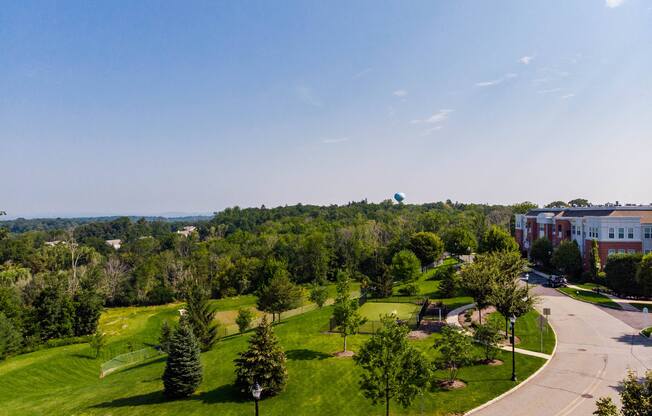 an aerial view of a park with trees and buildings