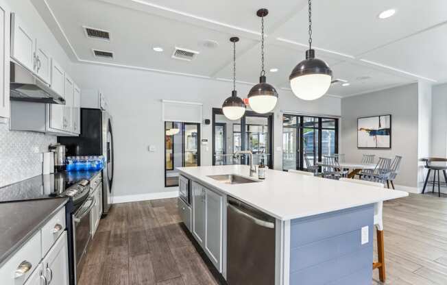 a large kitchen with an island and stainless steel appliances