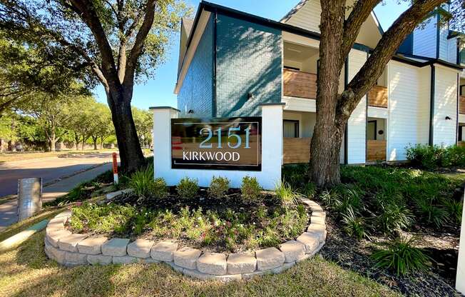 a sign with the address of a home with trees in the background  at 2151 Kirkwood, Houston, TX, 77077