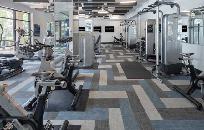 a fitness room with cardio machines and other exercise equipment at The Hendrix, Atlanta, GA, 30329
