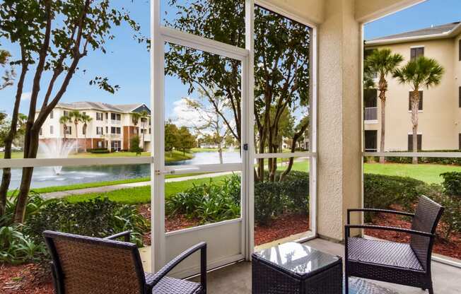 a patio with a table and chairs and a large window