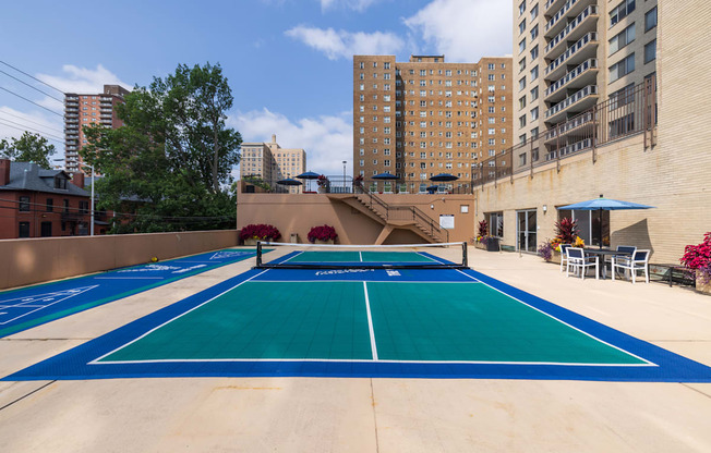 a blue and green tennis court on the roof of a building