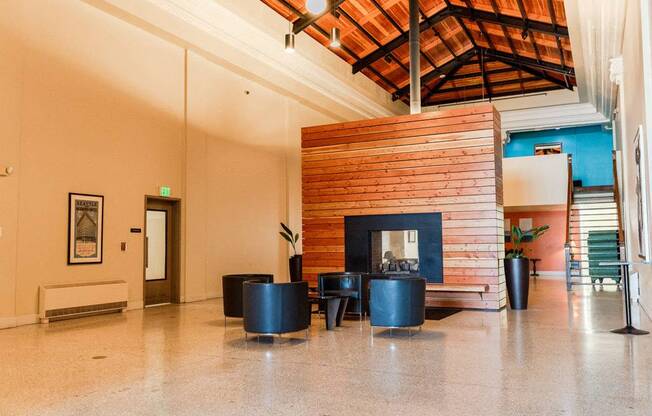 A room with a fireplace and a wooden ceiling at Addison on Fourth Apartments, Seattle