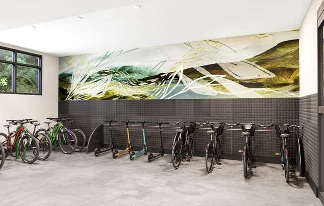 a row of bikes parked in front of a wall with a mural at Link Apartments® CYKEL Apartments, Charlotte , NC