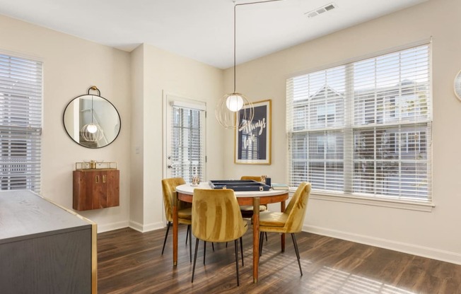 a dining room with a table and chairs and a window at Residences at Stevens Pond, Massachusetts