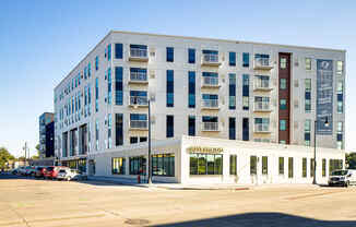 a new apartment building on the corner of a city street at Riverhouse Apartments, North Dakota