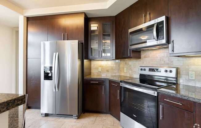 A kitchen with a stainless steel refrigerator and oven.
