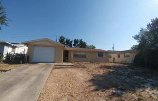 BEAUTIFUL 2/2/1 1060 sq ft home with indoor laundry, a full garage, updated kitchen and a fenced in yard!!