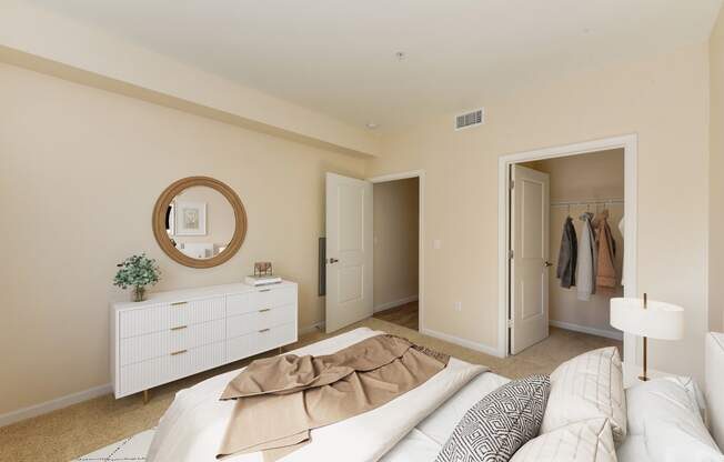 a bedroom with a bed and dresser and a closet