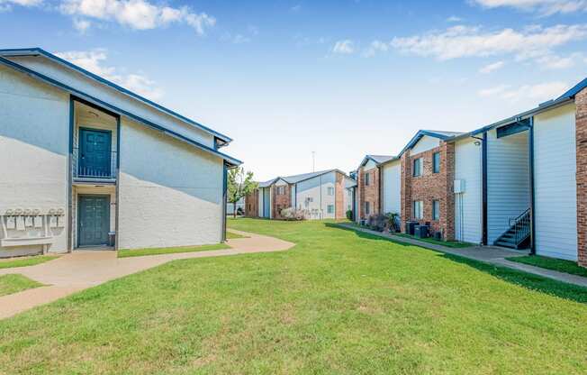 A row of houses with blue doors and windows.