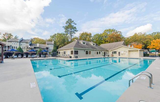 a large swimming pool with the building in the background