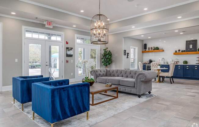 A living room with a grey sofa, a blue chair and a wooden coffee table.