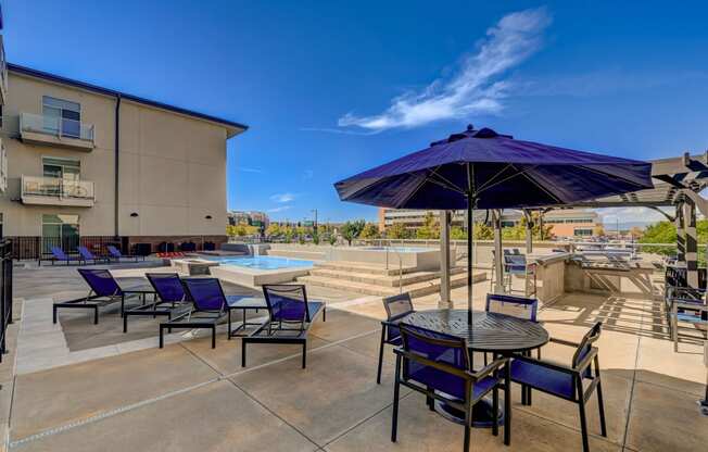 our apartments have a large patio with tables and chairs and a pool