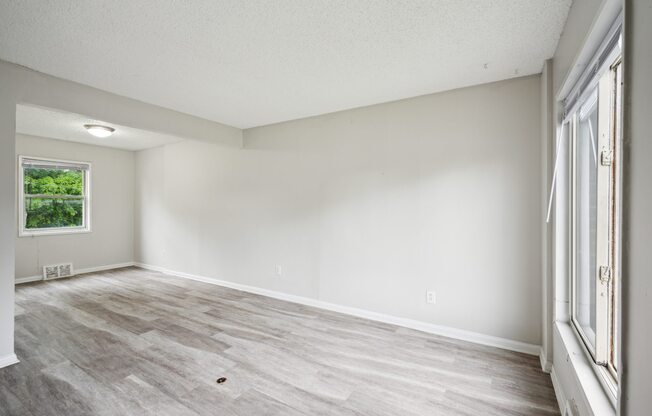 A room with a window and a door.