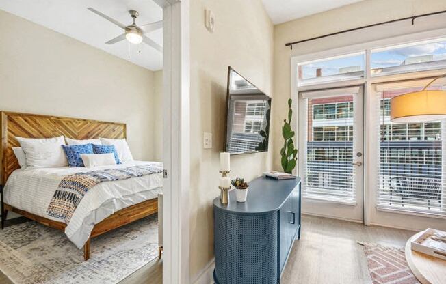 a bedroom with a bed and a door to a balcony at Link Apartments Innovation Quarter, North Carolina, 27101