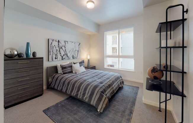 a bedroom with a bed and a dresser and a window at OLiVE DTLA in Los Angeles, California 90015