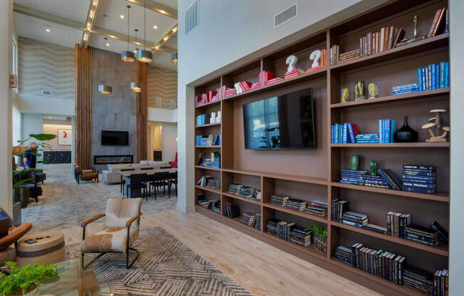 a living room with a large book shelf and a television