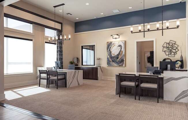 A modern office space with a reception desk and two workstations.
