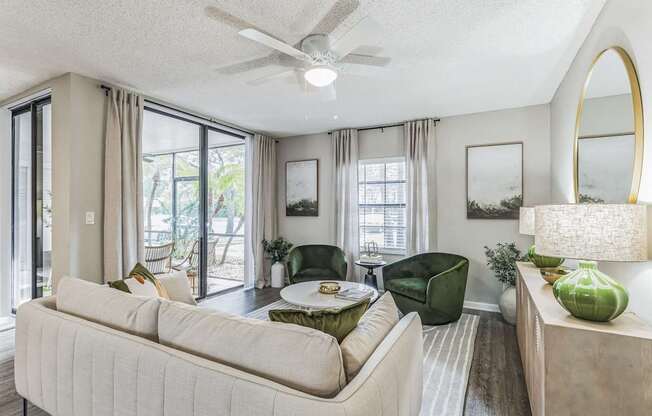 Living room with a couch and a table and a ceiling fan at The Atlantic Preserve, Plantation, FL.