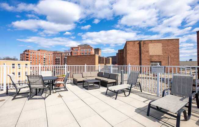 A patio with chairs and a table is set up on a rooftop.