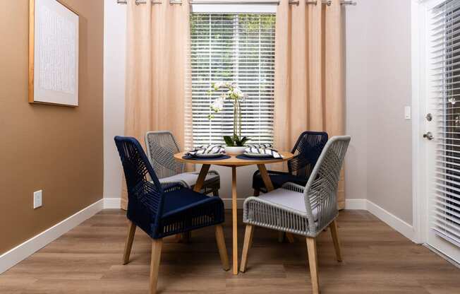 a dining room with a table and chairs and a window