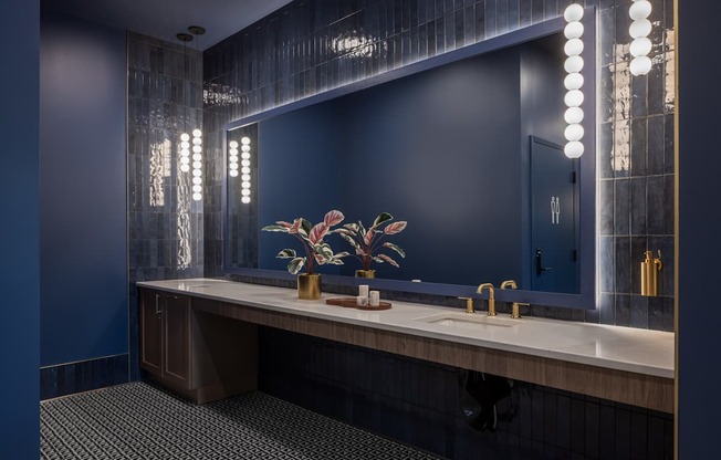 A bathroom with a vanity, sink, and mirror.
