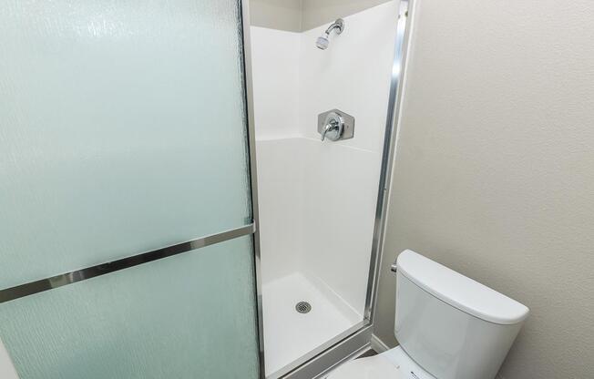 a white sink sitting next to a shower