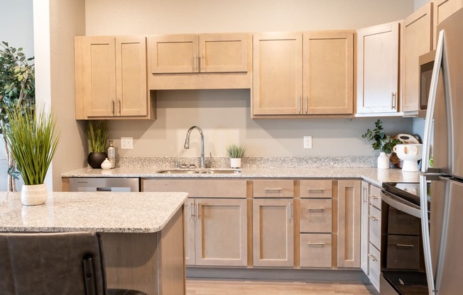 a kitchen with wooden cabinets and granite counter tops