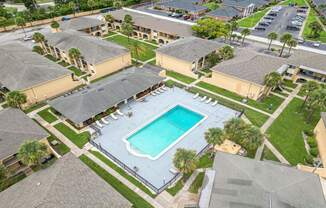 an aerial view of a swimming pool in front of some houses