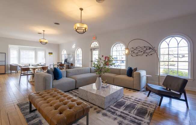 a living room with couches and chairs and a table