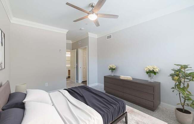 a bedroom with a bed and a ceiling fan