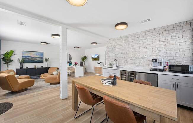 A modern kitchen with a wooden table and chairs.