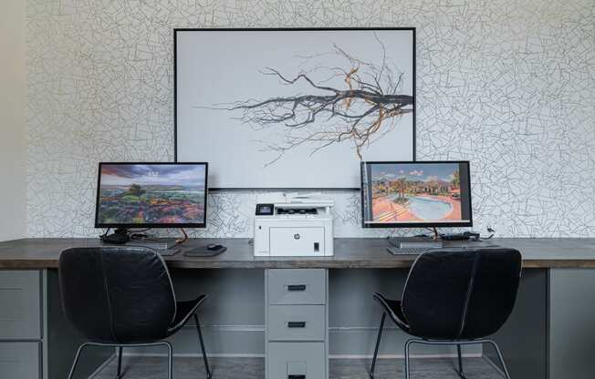 a desk with two computer monitors on top of it