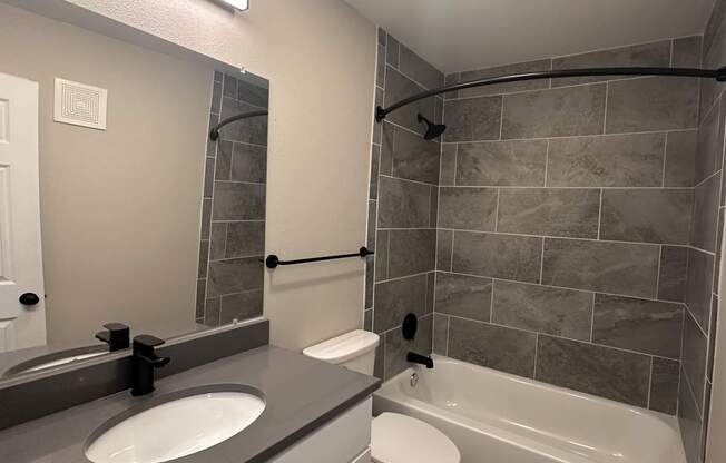 A bathroom with a white toilet and a white sink.