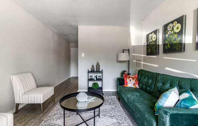 a living room with a green couch and a coffee table