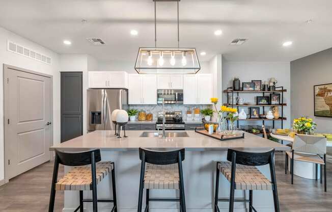 a kitchen with a large island with three stools at Weylyn Luxury Apartments, Arizona