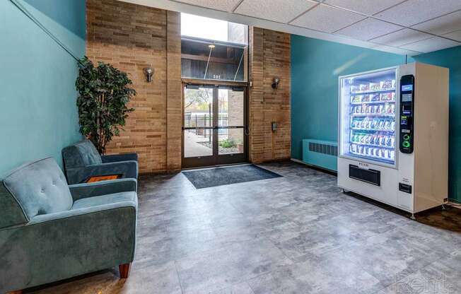 a lobby with a couch and a vending machine